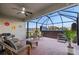 Inviting screened patio featuring brick flooring, comfortable seating, and string lights for relaxing outdoor enjoyment at 16032 Galiano Ct, Punta Gorda, FL 33955
