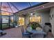 Cozy screened-in patio features stylish wicker furniture and a ceiling fan at 16032 Galiano Ct, Punta Gorda, FL 33955