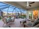 Relaxing screened patio with a ceiling fan and comfortable seating for outdoor entertaining near a hot tub at 16032 Galiano Ct, Punta Gorda, FL 33955
