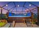 The screened-in patio area features a hot tub and charming string lights at 16032 Galiano Ct, Punta Gorda, FL 33955