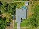 Aerial view of the property showing the house, pool, shed, and surrounding landscape at 17396 Cox Ave, Port Charlotte, FL 33948