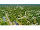 Aerial view of the property showcasing the surrounding neighborhood, lush greenery, and serene atmosphere at 17396 Cox Ave, Port Charlotte, FL 33948