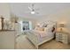 Calm bedroom features a plush bed, natural light, and light tones at 17396 Cox Ave, Port Charlotte, FL 33948