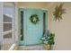 Charming front door with decorative wreath, sidelights, and tasteful accents creating a welcoming entrance at 17396 Cox Ave, Port Charlotte, FL 33948