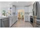 Updated kitchen boasts stainless steel appliances, gray cabinets, and an adjacent dining area at 17396 Cox Ave, Port Charlotte, FL 33948