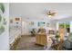 Bright living room with light wood floors, woven furniture, and seamless flow to kitchen at 17396 Cox Ave, Port Charlotte, FL 33948