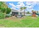 Spacious backyard featuring a patio, play set, and lush lawn at 17629 Palmetto Pass Ln, Punta Gorda, FL 33982