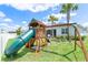Backyard with a wooden playset that includes a slide and swings for outdoor fun at 17629 Palmetto Pass Ln, Punta Gorda, FL 33982