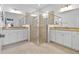 Bathroom with dual sinks, granite countertops, and a glass-enclosed shower at 17629 Palmetto Pass Ln, Punta Gorda, FL 33982