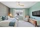 Comfortable bedroom featuring a decorative accent wall, ceiling fan, and lots of natural light at 17629 Palmetto Pass Ln, Punta Gorda, FL 33982