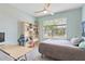 Comfortable bedroom with large window, ceiling fan, desk, and bookshelf, perfect for study and rest at 17629 Palmetto Pass Ln, Punta Gorda, FL 33982