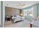 Comfortable bedroom featuring a decorative accent wall, ceiling fan, and lots of natural light at 17629 Palmetto Pass Ln, Punta Gorda, FL 33982