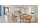 Bright kitchen with white cabinets, granite countertops, stainless steel appliances, and barstool seating at 17629 Palmetto Pass Ln, Punta Gorda, FL 33982