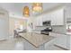 Charming kitchen with white cabinets, granite countertops, and modern stainless steel appliances at 17629 Palmetto Pass Ln, Punta Gorda, FL 33982