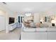 Bright, open living room featuring modern furnishings, tile floors and a decorative chandelier at 17629 Palmetto Pass Ln, Punta Gorda, FL 33982