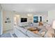 Bright, open living room featuring modern furnishings, tile floors and a decorative chandelier at 17629 Palmetto Pass Ln, Punta Gorda, FL 33982