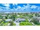 Aerial view of property featuring waterfront canal access, private pool, lush landscaping and a gray roof at 192 Danforth S Dr, Port Charlotte, FL 33980