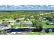 Aerial shot featuring waterfront home with canal access, a private dock, and surrounded by lush greenery at 192 Danforth S Dr, Port Charlotte, FL 33980