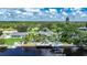 Aerial perspective of a waterfront residence boasting a private dock, outdoor seating area, and canal views at 192 Danforth S Dr, Port Charlotte, FL 33980
