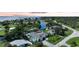 Stunning aerial view showcasing the home's waterfront location, private dock, and lush landscaping at 192 Danforth S Dr, Port Charlotte, FL 33980