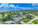 Scenic aerial view of a waterfront property with a private boat dock, vibrant landscaping, and canal access at 192 Danforth S Dr, Port Charlotte, FL 33980