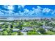 Aerial view of waterfront homes and properties in a scenic neighborhood with boat access at 192 Danforth S Dr, Port Charlotte, FL 33980