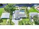 Aerial view of property featuring waterfront canal access, private pool, lush landscaping and a gray roof at 192 Danforth S Dr, Port Charlotte, FL 33980