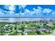 Stunning aerial view of waterfront homes with canals, lush landscaping, and a beautiful bay in the background at 192 Danforth S Dr, Port Charlotte, FL 33980