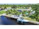 Overhead view of a waterfront property, showcasing private dock, beautiful landscaping, and tranquil canal waters at 192 Danforth S Dr, Port Charlotte, FL 33980