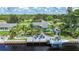 High-angle shot of waterfront home highlighting a dock, patio with seating, and access to the canal at 192 Danforth S Dr, Port Charlotte, FL 33980