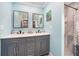 Spacious bathroom featuring a double sink vanity, with a shower and walk-in closet on either side at 192 Danforth S Dr, Port Charlotte, FL 33980