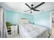 Bright bedroom with white furniture, blue walls, and ceiling fan at 192 Danforth S Dr, Port Charlotte, FL 33980