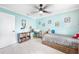 Bright, airy bedroom featuring a twin bed, ceiling fan, white trim and blue walls at 192 Danforth S Dr, Port Charlotte, FL 33980