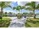 Waterfront outdoor space with dock, boat, seating, and lush landscaping at 192 Danforth S Dr, Port Charlotte, FL 33980