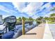 View of the dock in the backyard overlooking the water, equipped with boat and lift at 192 Danforth S Dr, Port Charlotte, FL 33980