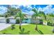 Charming single-story home featuring stone accents, a paved driveway, and lush landscaping with palm trees at 192 Danforth S Dr, Port Charlotte, FL 33980