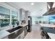 Close up of a modern sink and appliances in an updated kitchen with views of a pool and outdoor seating at 192 Danforth S Dr, Port Charlotte, FL 33980