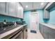 Updated laundry room with stainless steel washer and dryer and gray cabinetry at 192 Danforth S Dr, Port Charlotte, FL 33980