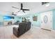 Inviting living room featuring a large TV, comfortable seating, and bright natural light at 192 Danforth S Dr, Port Charlotte, FL 33980