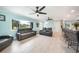 Bright living room with sleek leather furniture, ceiling fans, and a stylish view of the kitchen island at 192 Danforth S Dr, Port Charlotte, FL 33980
