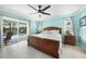 This bedroom features a ceiling fan and access to the patio through sliding glass doors at 192 Danforth S Dr, Port Charlotte, FL 33980