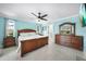 The main bedroom offers tile flooring, a ceiling fan, and furniture at 192 Danforth S Dr, Port Charlotte, FL 33980