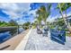 Enjoy the outdoors with comfortable seating around the fire pit on the paver patio overlooking the canal waters at 192 Danforth S Dr, Port Charlotte, FL 33980