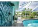 Outdoor shower with blue tile accent wall near a screened pool at 192 Danforth S Dr, Port Charlotte, FL 33980