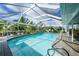 Beautiful screened-in pool with a brick deck and seating area at 192 Danforth S Dr, Port Charlotte, FL 33980