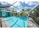 Beautiful screened-in pool, featuring clear water and a tropical view at 192 Danforth S Dr, Port Charlotte, FL 33980