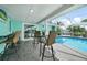 Relaxing screened-in patio with bar seating, pool, and views of the canal at 192 Danforth S Dr, Port Charlotte, FL 33980