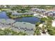 Expansive aerial view of the residential complex, complete with a community pool and water features, offers resort-style living at 206 Gondola Park Dr # 206, Venice, FL 34292