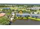 Gorgeous aerial shot featuring the condo complex, surrounded by lush greenery and a serene lake, an idyllic setting at 206 Gondola Park Dr # 206, Venice, FL 34292