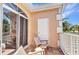 Balcony featuring tiled flooring, outdoor chairs, and views of the surrounding neighborhood at 206 Gondola Park Dr # 206, Venice, FL 34292